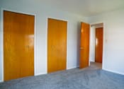 Thumbnail 10 of 20 - three doors in a room with carpet and white walls
