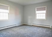 Thumbnail 11 of 20 - an empty room with two windows and a carpet