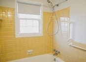 Thumbnail 12 of 20 - a bathroom with a tub and a shower and a window