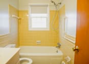 Thumbnail 14 of 20 - a bathroom with a tub and a toilet and a window