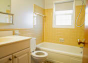 Thumbnail 13 of 20 - a bathroom with a toilet and a tub and a sink