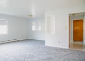 Thumbnail 7 of 20 - an empty living room with white walls and white carpet