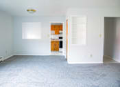 Thumbnail 5 of 20 - an empty living room with white walls and a white carpet