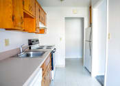 Thumbnail 2 of 20 - an empty kitchen with a sink and a refrigerator