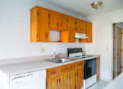 Thumbnail 3 of 20 - a kitchen with white appliances and wooden cabinets