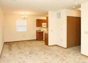 Thumbnail 8 of 15 - A room with a kitchenette and a window.