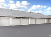 Thumbnail 14 of 15 - A row of white garage doors on a grey building.