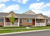 Thumbnail 1 of 15 - A two-story brick house with a red door and white fence.