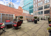 Thumbnail 34 of 35 - an outdoor patio with tables and chairs and tall buildings at Market Square Place, Pennsylvania
