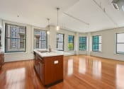 Thumbnail 19 of 35 - an empty kitchen with wood floors and a counter top at Market Square Place, Pennsylvania