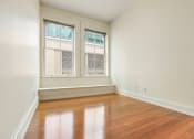 Thumbnail 22 of 35 - an empty bedroom or office with large windows and hard wood floors at Market Square Place, Pennsylvania