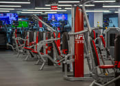 Thumbnail 25 of 35 - a row of exercise machines at UFC Gym equipment at Market Square Place, Pittsburgh, PA at Market Square Place, Pennsylvania