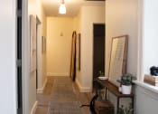 Thumbnail 6 of 35 - a hallway with a carpeted floor and white walls and a door at Market Square Place, Pennsylvania