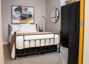Thumbnail 8 of 35 - a bedroom with a bed and a painting on the wall at Market Square Place, Pennsylvania