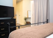 Thumbnail 9 of 35 - a bedroom with a bed and a television at Market Square Place, Pennsylvania
