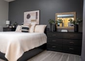 Thumbnail 15 of 35 - a bedroom with black furniture and a white bed at Market Square Place, Pennsylvania