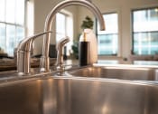 Thumbnail 16 of 35 - a stainless steel kitchen sink with two faucets at Market Square Place, Pennsylvania