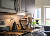 Thumbnail 17 of 35 - a kitchen with a stove and a coffee maker on the counter at Market Square Place, Pennsylvania