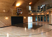 Thumbnail 3 of 3 - a basketball court in a wood paneled gym
