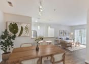 Thumbnail 1 of 26 - a living room and dining room with a wooden table and chairs at Highlands at Faxon Woods, Quincy, Massachusetts