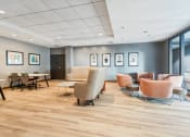 Thumbnail 14 of 23 - a clubroom with seating and a coworking space at Residences at Manchester Place in Manchester, New Hampshire