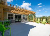 Thumbnail 28 of 33 - a patio with a pergola and chairs at Edgebrook Residences, Merrimack