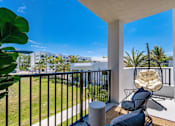 Thumbnail 11 of 46 - A Balcony with a Chair at The Palmeri Residences, Florida, 34104