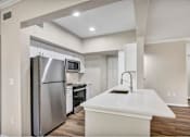 Thumbnail 3 of 35 - Renovated deluxe home featuring white cabinets and stainless steel appliances at The Lodge at Lakeline Village, Cedar Park, 78613