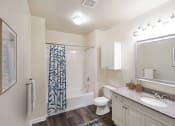 Thumbnail 4 of 26 - a bathroom with a shower toilet and sink and a mirror at Highlands at Faxon Woods, Quincy, MA, 02169