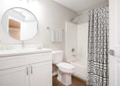 Thumbnail 5 of 30 - a bathroom with white cabinets and a black and white shower curtain  at Ashlar, Fort Myers, Florida