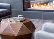 Thumbnail 39 of 40 - a coffee table in front of a fireplace in a living room at Maven on Broadway, Minnesota, 55904