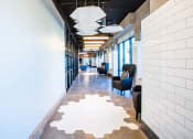 Thumbnail 37 of 52 - a long corridor with blue chairs and white tile on the floor at 511 Meeting, Charleston, South Carolina