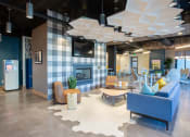 Thumbnail 33 of 52 - a lobby with blue couches and chairs and a fireplace at 511 Meeting, South Carolina, 29403