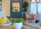 Thumbnail 24 of 52 - a room with a blue wall with a painting of a yellow house on it at 511 Meeting, South Carolina