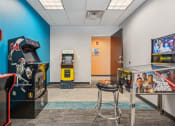 Thumbnail 17 of 23 - a game room with arcade games at the Residences at Manchester Place in Manchester, New Hampshire