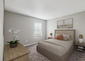 Thumbnail 4 of 23 - A bedroom with a large bed, a nightstand, and a table with a vase of flowers.