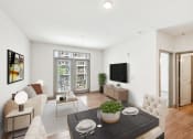 Thumbnail 2 of 22 - a living room with a couch and a table at Glenwood at Grant Park Apartments, Atlanta, Georgia