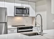 Thumbnail 2 of 35 - Renovated deluxe home featuring white cabinets and stainless steel appliances at The Lodge at Lakeline Village, Texas, 78613