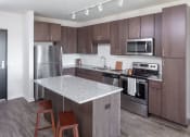 Thumbnail 4 of 40 - a kitchen with stainless steel appliances and a marble counter top at Maven on Broadway, Minnesota