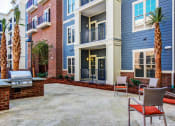 Thumbnail 19 of 23 - Poolside grills and patio at The Standard, Charleston, SC