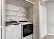 Thumbnail 5 of 27 - a white washer and dryer in a laundry room with a white door at Altezza High Desert, Albuquerque