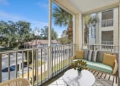 Thumbnail 11 of 31 - a patio with a couch and a table on a balcony at Grandeville on Saxon, Orange City