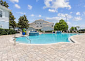 Thumbnail 12 of 23 - Community Pool with Lounge Chairs at Ballantrae Apartments, Sanford