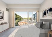 Thumbnail 3 of 23 - a bedroom with a bed and a large window at the Residences at Manchester Place in Manchester, New Hampshire