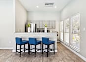 Thumbnail 24 of 27 - A Kitchen with a Bar Chairs at Flats on Chapel Apartments, Texas