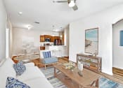 Thumbnail 2 of 31 - a living room with a couch and a table