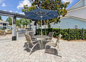 Thumbnail 14 of 23 - A BBQ and Grill area featuring a patio table and chairs