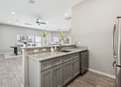 Thumbnail 25 of 27 - A Kitchen with a Marble Countertop at Flats on Chapel Apartments, Waco, Texas