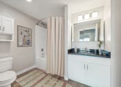 Thumbnail 4 of 23 - a bathroom with a shower and a sink at the Residences at Manchester Place in Manchester, New Hampshire
