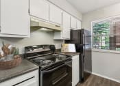 Thumbnail 15 of 33 - our apartments offer a modern kitchen with stainless steel appliances at Acacia Gardens, Albuquerque, NM, 87111